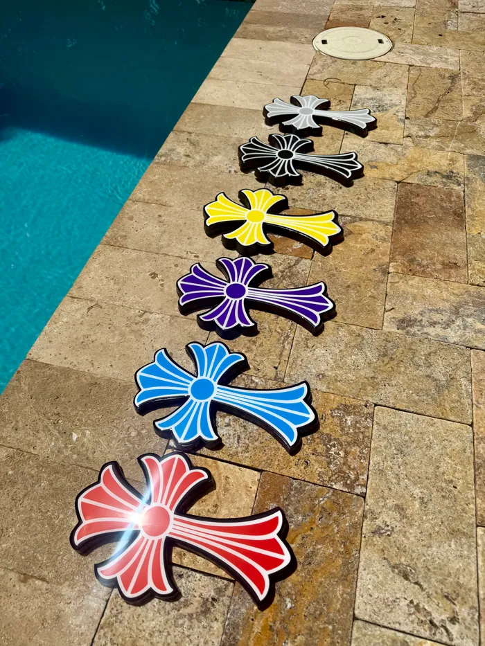 Six epoxy crosses in a row beside a swimming pool