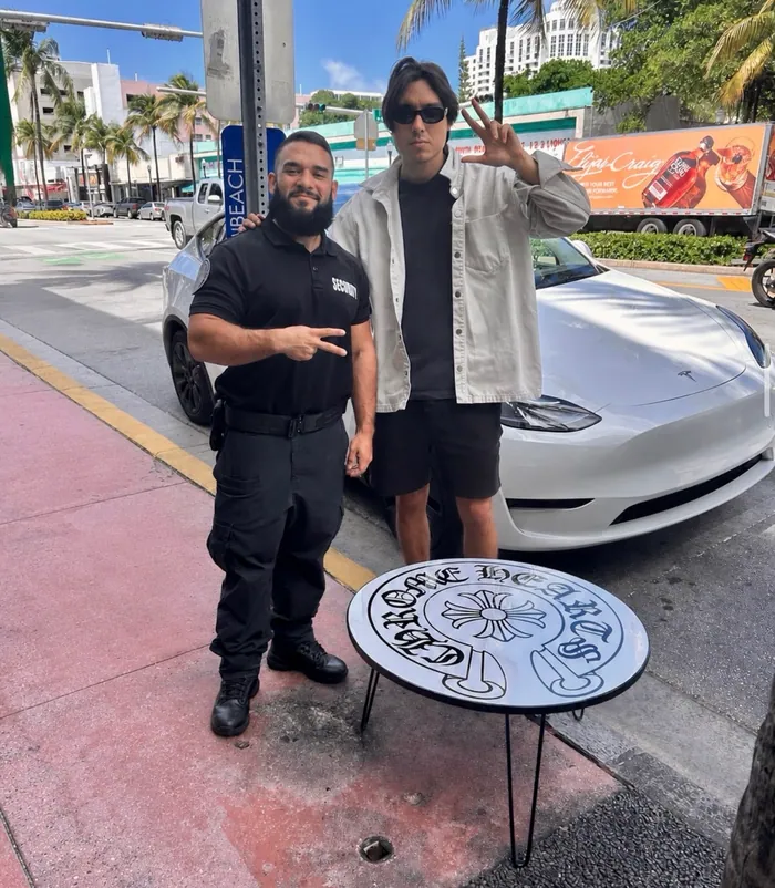 A round custom epoxy table with a gothic cross design on a Miami Beach sidewalk